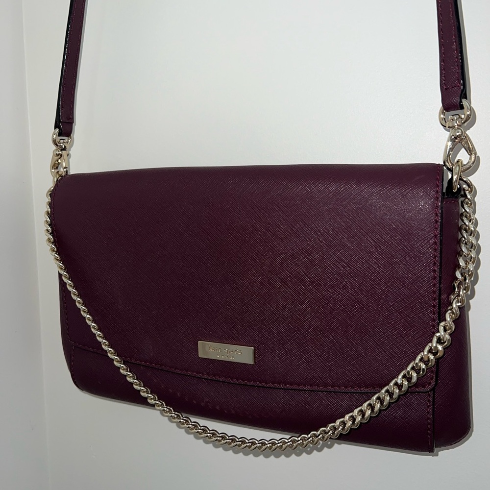 Maroon Kate Spade crossbody with gold hardware.